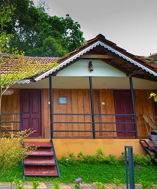Paddy-view wooden cottage in the Kabini Mystery Maze resort with a view of a paddy field