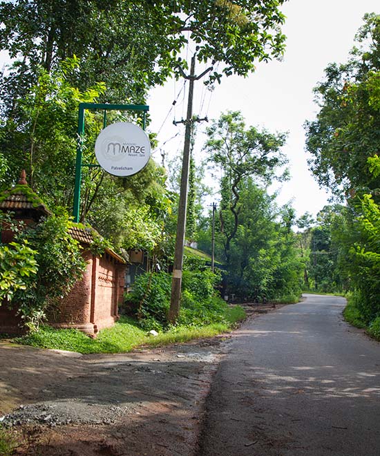 Outside view of Kabini Mysterymaze Resort, featuring the elegant entrance, inviting naming board of the Mystery maze, and serene surroundings