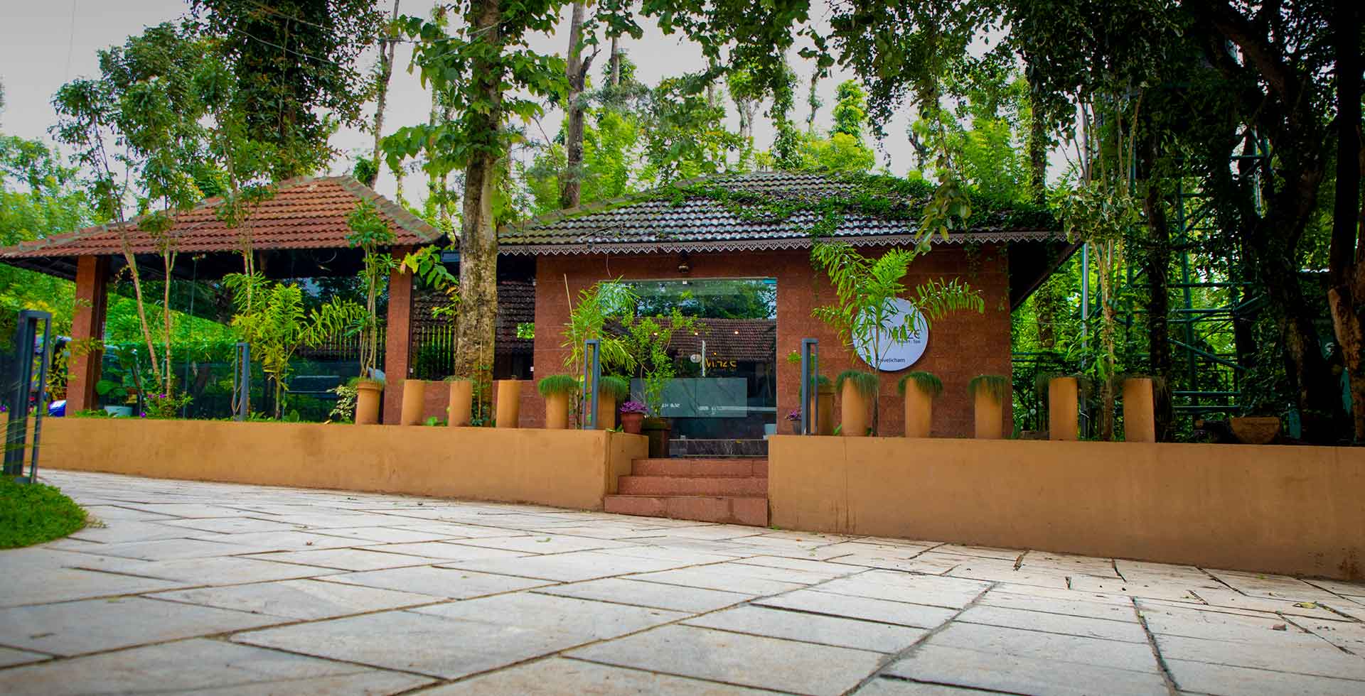 Front view of the Kabini Mystery Maze  resort, showing the grand entrance